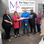 Chas Andrews, Latorya Odum and Maria Resendix from American Woodmark in Lincolnton present a 3,000 dollar check to Leslie Hulbert of Malorie's Place