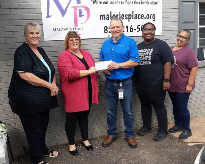 Chas Andrews, Latorya Odum and Maria Resendix from American Woodmark in Lincolnton present a 3,000 dollar check to Leslie Hulbert of Malorie's Place