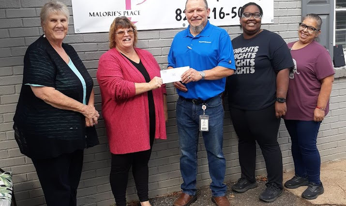 Chas Andrews, Latorya Odum and Maria Resendix from American Woodmark in Lincolnton present a 3,000 dollar check to Leslie Hulbert of Malorie's Place