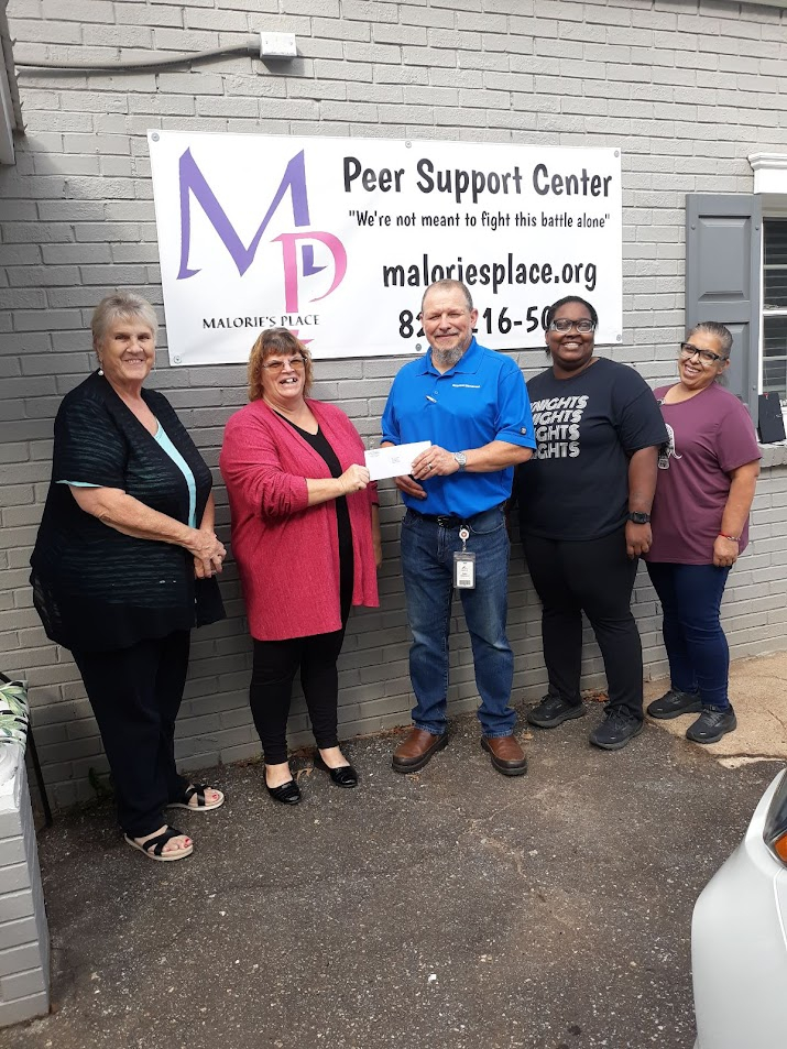 Chas Andrews, Latorya Odum and Maria Resendix from American Woodmark in Lincolnton present a 3,000 dollar check to Leslie Hulbert of Malorie's Place